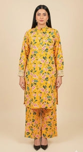 Woman wearing a yellow floral outfit on a beige background