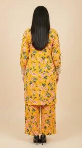 Woman wearing a yellow floral dress against a beige background