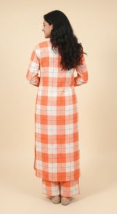 Woman wearing a checkered dress with a beige background
