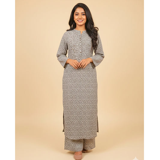 Woman wearing a long, patterned dress against a beige background