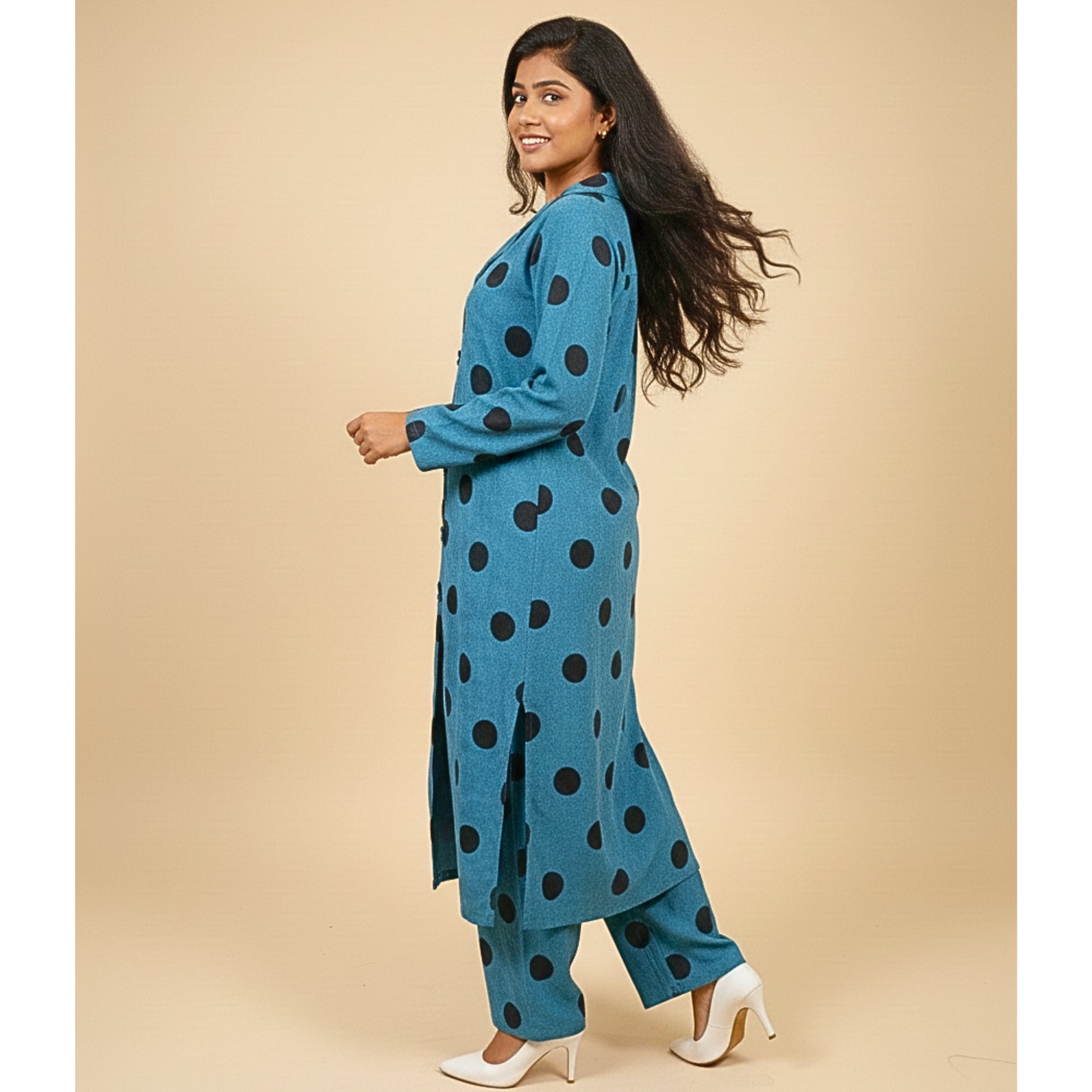 Woman wearing a blue polka dot outfit on a beige background